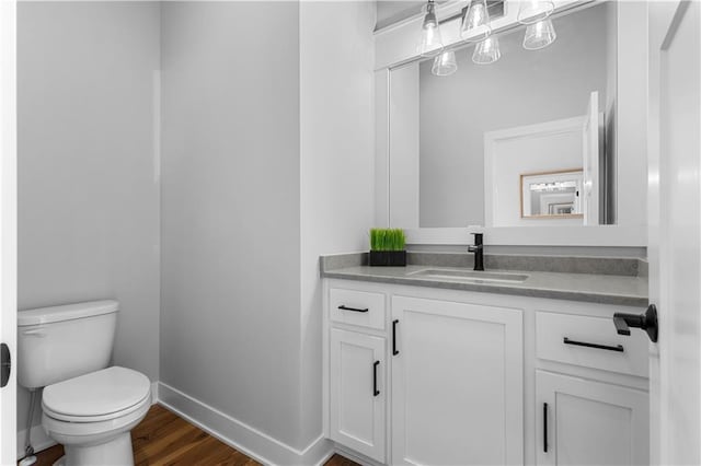 bathroom featuring hardwood / wood-style flooring, vanity, and toilet