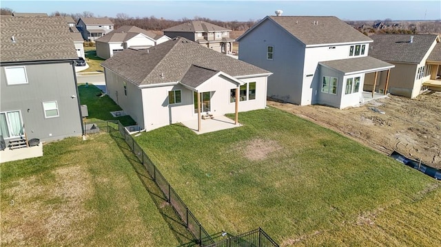 rear view of property featuring a lawn and a patio area