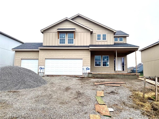 view of front of house with a porch, a garage, board and batten siding, and driveway