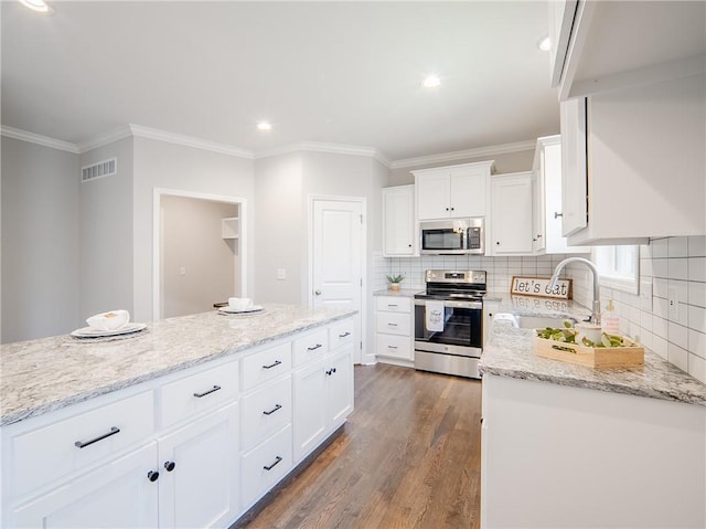 kitchen with dark wood finished floors, white cabinetry, visible vents, and appliances with stainless steel finishes