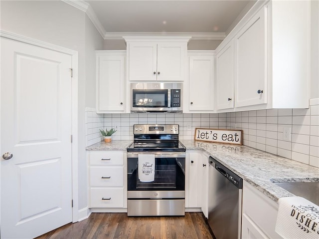 kitchen featuring crown molding, white cabinets, dark wood-style flooring, and appliances with stainless steel finishes