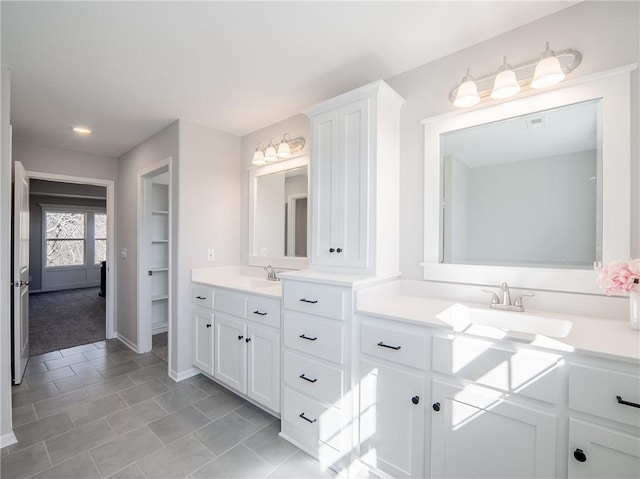 full bathroom featuring tile patterned floors, vanity, and baseboards