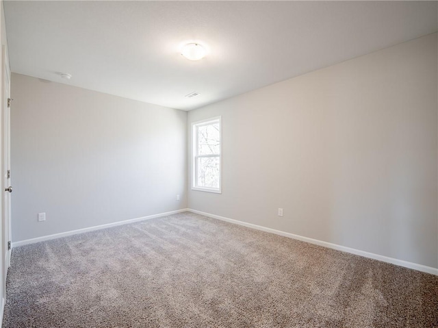 carpeted empty room with baseboards