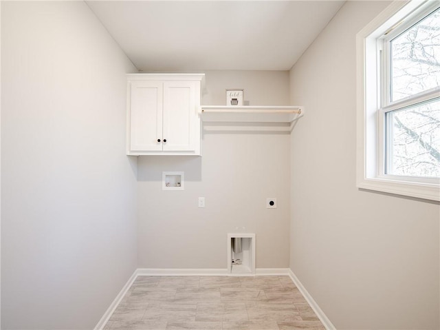 clothes washing area featuring cabinet space, a healthy amount of sunlight, hookup for an electric dryer, and hookup for a washing machine