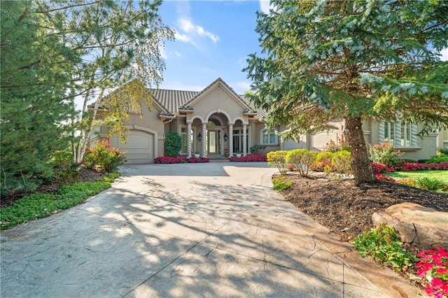 21111 W 95th Ter, Lenexa, KS 66220 - view of front of home with concrete driveway, a garage, and stucco siding