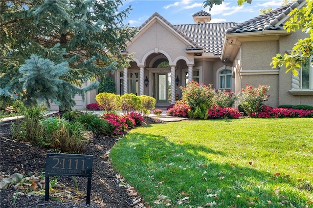 21111 W 95th Ter, Lenexa, KS 66220 - exterior space featuring a front lawn, a tile roof, and stucco siding