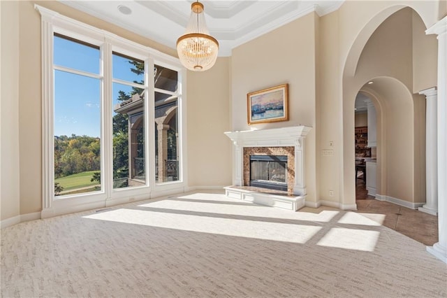 21111 W 95th Ter, Lenexa, KS 66220 - unfurnished living room featuring a fireplace, an inviting chandelier, crown molding, and carpet floors