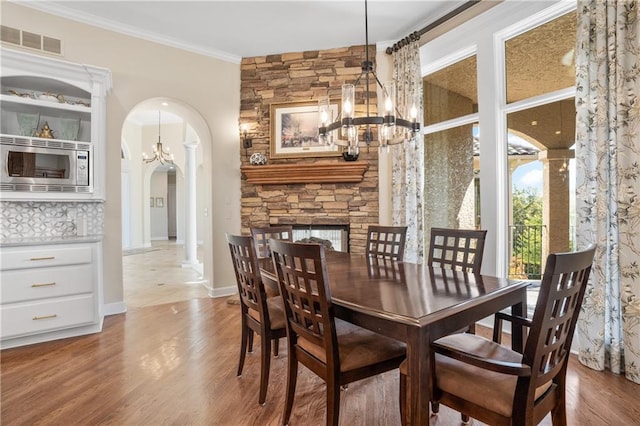 21111 W 95th Ter, Lenexa, KS 66220 - dining area with visible vents, arched walkways, an inviting chandelier, ornamental molding, and wood finished floors