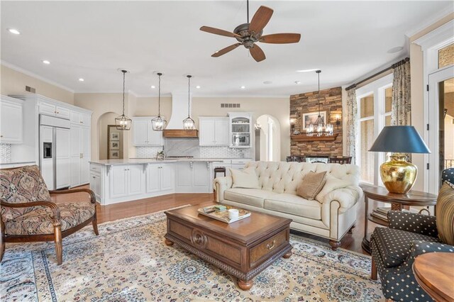 21111 W 95th Ter, Lenexa, KS 66220 - living area featuring recessed lighting, arched walkways, ceiling fan, and ornamental molding