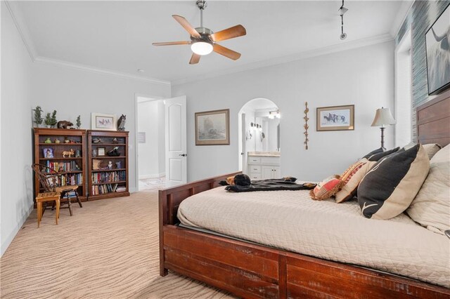 21111 W 95th Ter, Lenexa, KS 66220 - bedroom with connected bathroom, light colored carpet, arched walkways, ornamental molding, and a ceiling fan