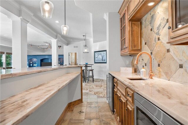 21111 W 95th Ter, Lenexa, KS 66220 - kitchen featuring light stone countertops, a sink, brown cabinetry, crown molding, and baseboards