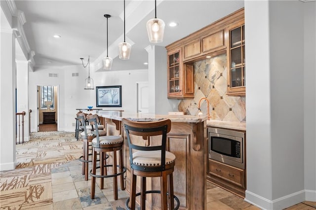 21111 W 95th Ter, Lenexa, KS 66220 - bar featuring stainless steel microwave, baseboards, recessed lighting, indoor wet bar, and backsplash