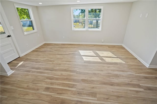 unfurnished room featuring light hardwood / wood-style flooring and plenty of natural light