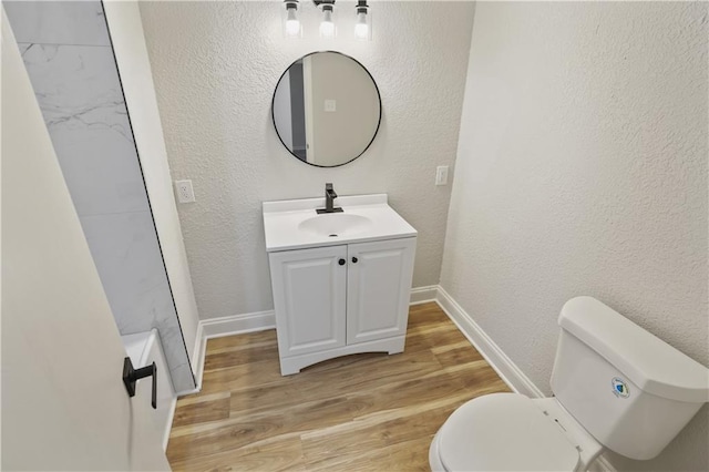 bathroom with vanity, hardwood / wood-style flooring, and toilet