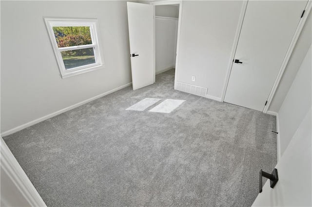 unfurnished bedroom featuring light carpet