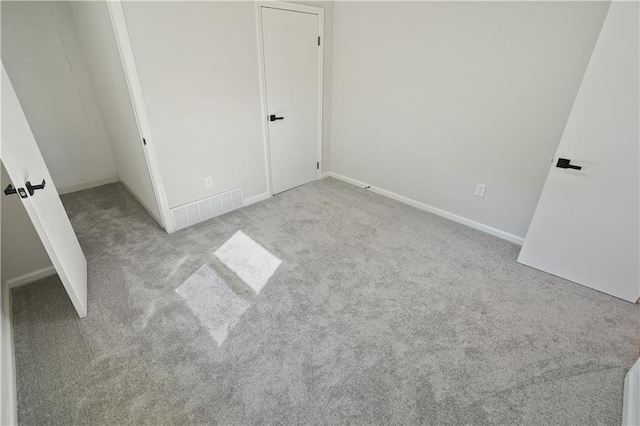 unfurnished bedroom with light colored carpet