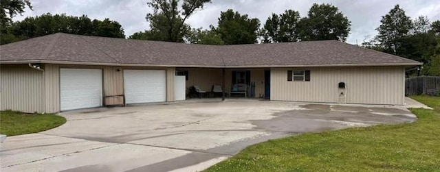 view of front of property with a garage and a front yard