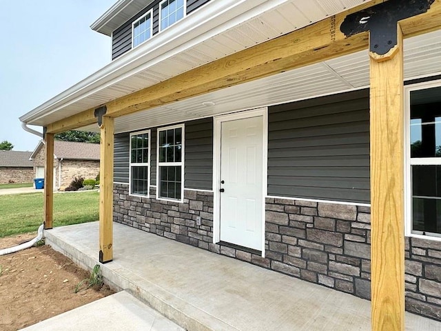 view of exterior entry with a porch