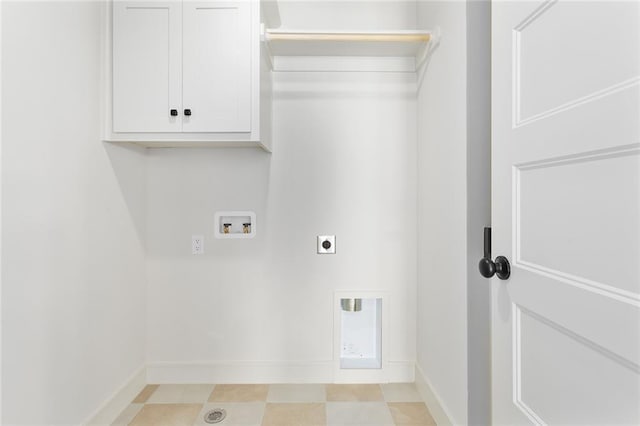 clothes washing area featuring cabinets, hookup for a washing machine, and hookup for an electric dryer