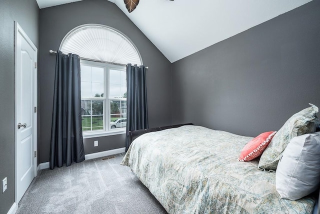 carpeted bedroom featuring lofted ceiling and ceiling fan