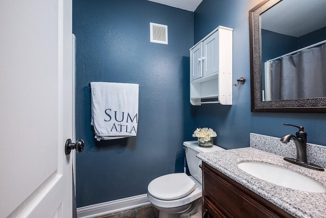 bathroom with vanity, toilet, and tile patterned floors