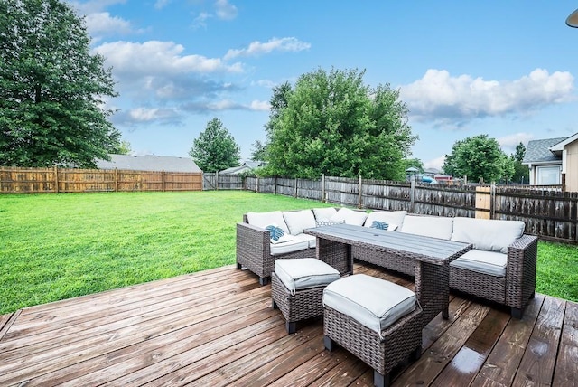 wooden deck with an outdoor living space and a lawn