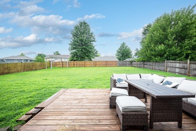 wooden terrace with an outdoor living space and a lawn