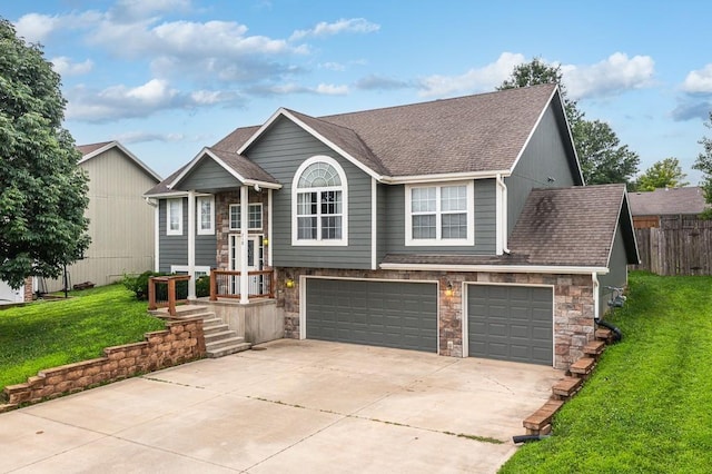 split foyer home with a front yard and a garage