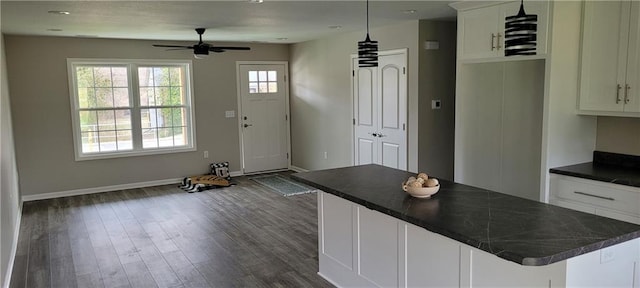 kitchen with dark hardwood / wood-style flooring, white cabinetry, and a wealth of natural light