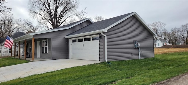 view of side of home featuring a porch, a garage, and a lawn