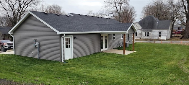 back of property featuring central AC and a lawn