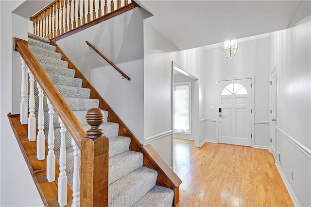 entryway with light wood-type flooring and a notable chandelier