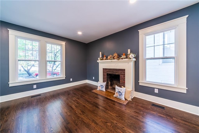 unfurnished living room with dark hardwood / wood-style flooring and a fireplace