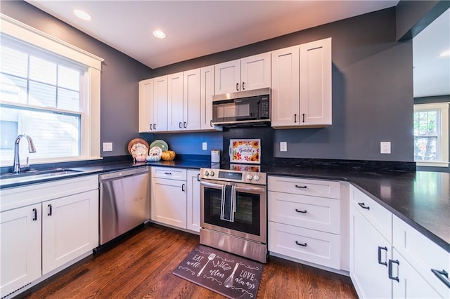 kitchen featuring white cabinets, stainless steel appliances, and dark hardwood / wood-style flooring