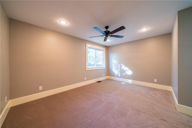 carpeted empty room featuring ceiling fan