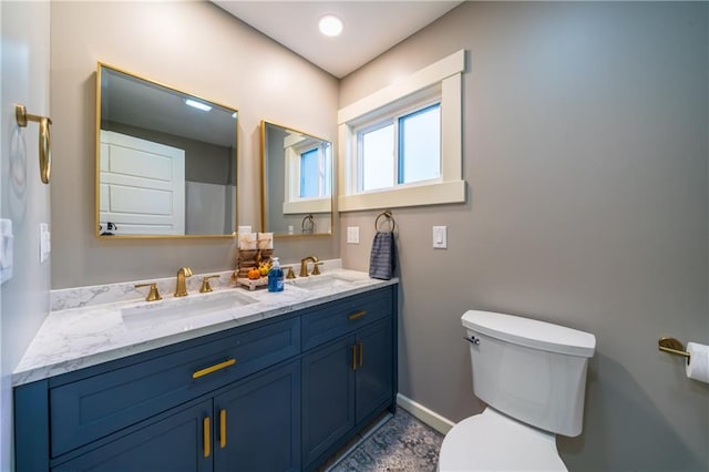 bathroom featuring toilet and vanity