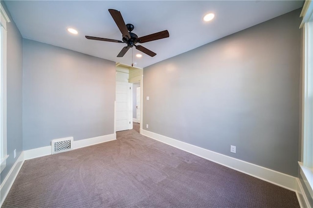 carpeted empty room featuring ceiling fan