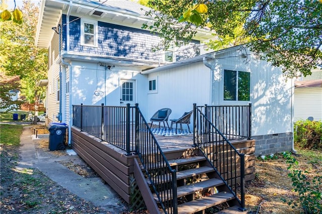 rear view of property featuring a wooden deck