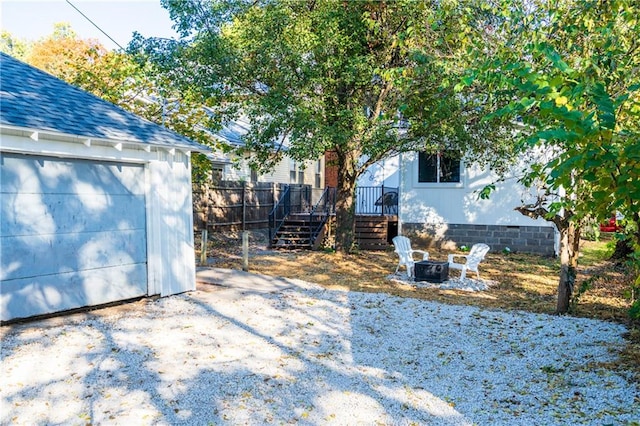 view of yard featuring a garage and an outbuilding