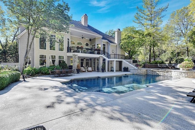 view of pool with a patio area and ceiling fan