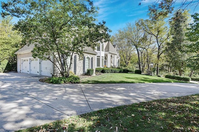 view of front of home with a front yard and a garage