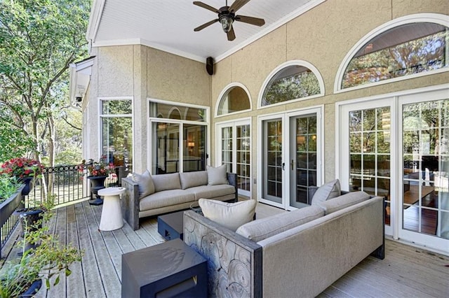 wooden terrace featuring an outdoor living space and ceiling fan