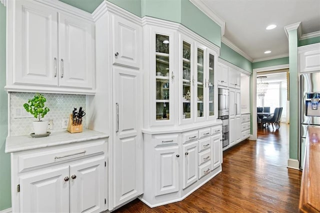 kitchen with stainless steel refrigerator with ice dispenser, white cabinetry, and dark hardwood / wood-style flooring