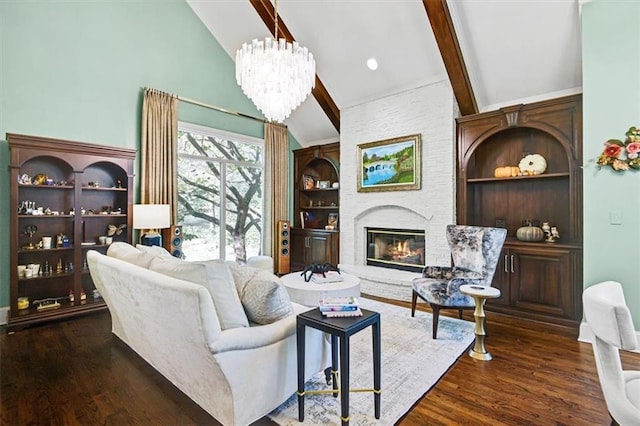 living room with vaulted ceiling with beams, dark hardwood / wood-style floors, a chandelier, and a fireplace