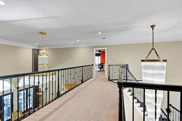 hall featuring a wealth of natural light, crown molding, and carpet flooring