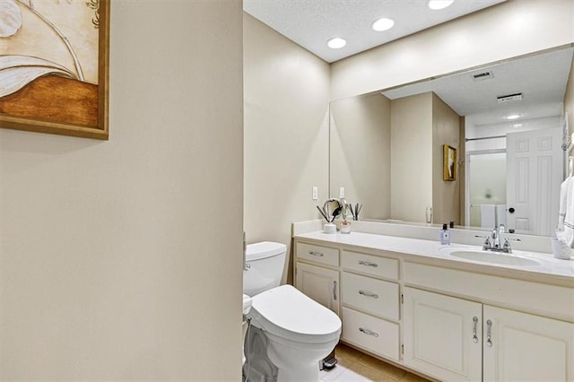 bathroom with vanity, toilet, and tile patterned flooring