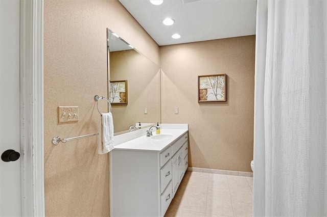 bathroom with vanity, toilet, and tile patterned floors