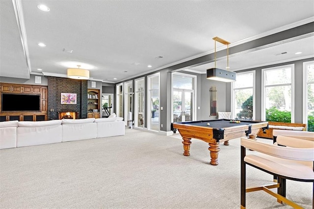 recreation room with billiards, crown molding, carpet floors, and a brick fireplace