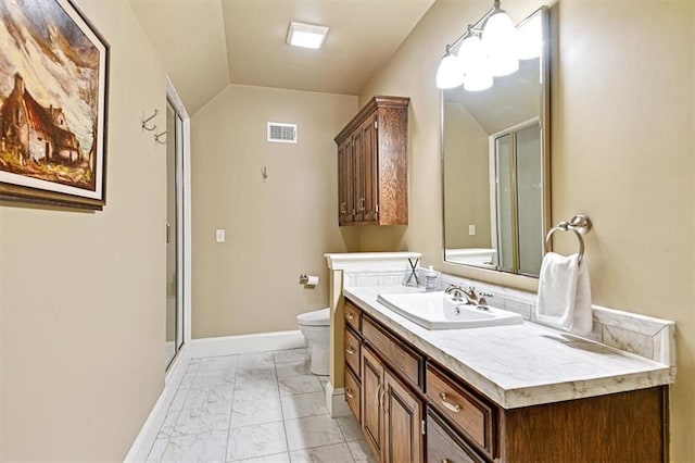 bathroom featuring vanity, a shower with shower door, toilet, and vaulted ceiling