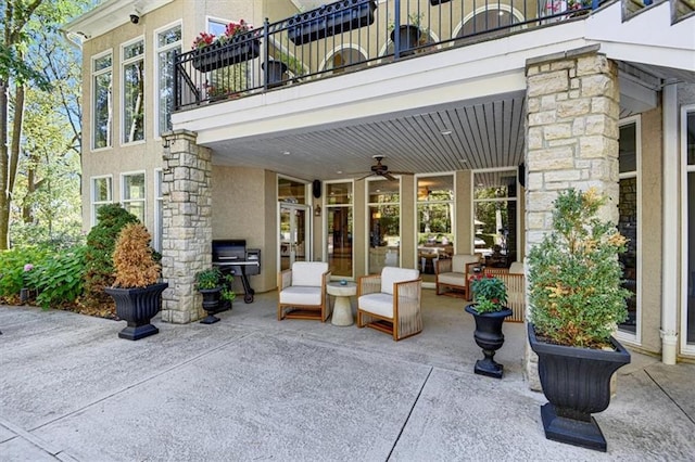 view of patio featuring ceiling fan and a balcony